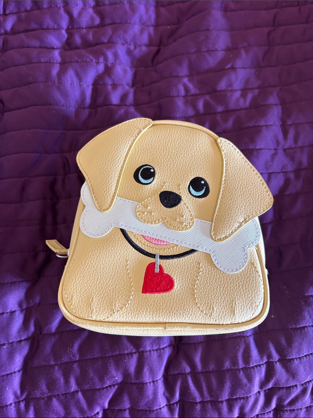 Yellow dog with floppy ears, a bone and heart collar makeup/travel bag
